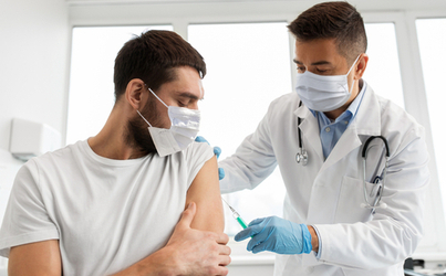 A man takes a vaccine